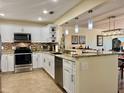 Modern kitchen featuring granite countertops, stainless steel appliances, and stylish backsplash at 100 Bluff View Dr # 115C, Belleair Bluffs, FL 33770