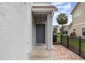 View of front door, with neutral paint, leading into a charming townhouse at 10966 Winter Crest Dr, Riverview, FL 33569