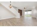 Spacious living room with hardwood floors, modern ceiling fan, and lots of natural light at 10966 Winter Crest Dr, Riverview, FL 33569