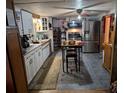 View of the kitchen with stainless steel appliances, white cabinets, and tile flooring at 12709 Greenland Dr, Riverview, FL 33579