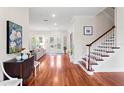 Bright foyer with hardwood floors, stairs, and views to the living room and the backyard at 131 Miramar Ne Blvd, St Petersburg, FL 33704