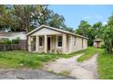 Side view of house with a spacious driveway, offering ample parking space at 14935 Julian St, Dade City, FL 33523