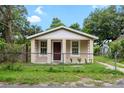 A charming home with a fenced front yard, perfect for outdoor enjoyment at 14935 Julian St, Dade City, FL 33523