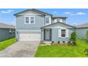 Charming two-story home featuring a beautifully landscaped front yard and a brick driveway leading to the garage at 1829 Draughton Dr, Zephyrhills, FL 33541