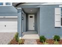 Inviting front entrance with a covered porch and well-maintained landscaping at 1829 Draughton Dr, Zephyrhills, FL 33541