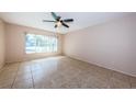 Bright bedroom with tile flooring, a ceiling fan, and a window letting in natural light at 2020 58Th N Way, Clearwater, FL 33760