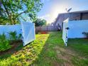 Spacious fenced backyard with an open gate leading to a well maintained green space at 22798 Penny Loop, Land O Lakes, FL 34639