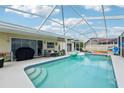 Inviting screened-in pool area with ample seating and a -safe fence at 2714 Witley Ave, Palm Harbor, FL 34685