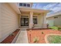 Inviting front porch featuring double doors, decorative columns, and manicured landscaping at 2957 Hickory Grove Dr, Valrico, FL 33596