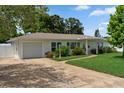 Charming single-story home with a well-maintained lawn, driveway, and attached garage during daytime at 3839 18Th N Ave, St Petersburg, FL 33713