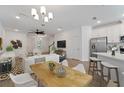 Open-concept living room and dining area with a ceiling fan, wooden floors, and lots of natural light at 4020 Via Sienna Cir, Sarasota, FL 34243