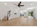 Spacious living area with hardwood floors and a staircase leading to the upper level at 4020 Via Sienna Cir, Sarasota, FL 34243