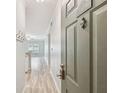 Inviting entryway featuring wood-look flooring, coat hooks, and a glimpse into the living area with natural light at 4207 S Dale Mabry Hwy # 2105, Tampa, FL 33611