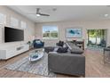Bright living room boasts wood floors, modern furniture, and sliding glass doors to the outdoor patio at 4212 W La Salle St, Tampa, FL 33607