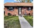 View of the facade of this property with brick exterior, windows with shutters, and manicured lawn at 5119 Hector Ct, Tampa, FL 33624
