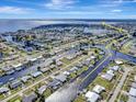 Expansive aerial view of a coastal neighborhood with interconnected waterways leading to the ocean at 551 Lindley Ter, Port Charlotte, FL 33952