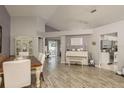Spacious dining and living area featuring wood-look floors, a piano, and access to the kitchen at 5826 Taywood Dr, Tampa, FL 33624
