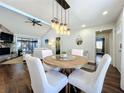 Cozy dining space with modern lighting fixture, open concept living, and backyard pool views at 6682 Mauna Loa Blvd, Sarasota, FL 34241