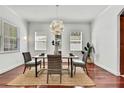 Bright dining room with modern light fixture, hardwood floors, and neutral decor at 710 W Peninsular St, Tampa, FL 33603