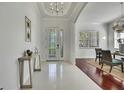 Elegant foyer featuring a chandelier, decorative glass front door, and an adjacent dining area at 710 W Peninsular St, Tampa, FL 33603
