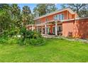 Expansive backyard features a covered patio, lush greenery, and an outdoor space perfect for relaxation and entertaining at 817 S West Shore Blvd, Tampa, FL 33609