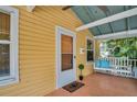 Inviting front porch with a swing, perfect for relaxing, and views of lush greenery at 844 10Th S Ave, St Petersburg, FL 33701