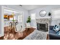 Cozy living room featuring a decorative fireplace, hardwood floors, and an open layout at 844 10Th S Ave, St Petersburg, FL 33701