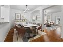 Open dining area with modern table, chairs, stylish lighting, and hardwood floors at 9418 W Park Village Dr # 105, Tampa, FL 33626