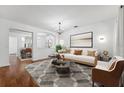 Bright living room featuring modern decor, stylish rug, and elegant chandelier at 9418 W Park Village Dr # 105, Tampa, FL 33626