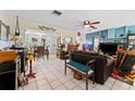 Spacious living room with tile flooring, ceiling fan, and comfortable seating, perfect for relaxation at 9602 N Rome Ave, Tampa, FL 33612