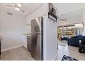 Modern kitchen with stainless steel appliances and a view into the living room at 10423 Carrollbrook Cir # 203, Tampa, FL 33618