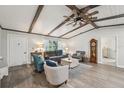 Inviting living room with wood beams, modern furnishings, and ample natural light at 10614 Hudson Ave, Hudson, FL 34669