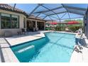Beautiful screened-in pool with outdoor dining and lounging areas at 11039 Calluna Dr, Odessa, FL 33556