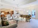 Bright, open-concept living room featuring high ceilings and seamless flow to the dining area at 11620 Eastern Star Ct, New Port Richey, FL 34654