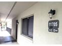 Exterior shot showing unit number with nearby doorway entrance at 11705 Raintree Village Blvd # C, Temple Terrace, FL 33617