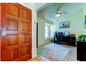 Inviting office space with a dark wood door, ceiling fan, and arched window at 12004 Plantain Ct, Tampa, FL 33635