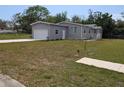 Charming single-story home featuring a garage, well-maintained lawn, and pleasant landscaping at 15591 Charmwood Dr, Hudson, FL 34667