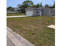 Charming single-story home featuring a garage, well-maintained lawn, and pleasant landscaping at 15591 Charmwood Dr, Hudson, FL 34667