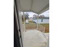 View from the porch showing the home's exterior and a glimpse of the surrounding landscape at 15591 Charmwood Dr, Hudson, FL 34667