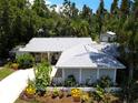 A nicely landscaped single-story home with mature trees at 1861 Royal Oak E Pl, Dunedin, FL 34698