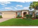 Inviting single-story home with a manicured lawn, brick-paved driveway, and cozy front porch in a well-kept neighborhood at 19418 Butterwood Ln, Lutz, FL 33558
