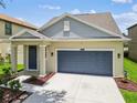 Single-Gathering home featuring a two-car garage and landscaping at 21284 Southern Charm Dr, Land O Lakes, FL 34637
