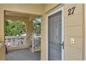 Welcoming entryway with a screen door and unit number, creating a warm and inviting atmosphere at 2253 Norwegian Dr # 27, Clearwater, FL 33763