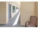 Well-lit hallway with a comfortable chair and unit doors, offering a sense of community and convenience at 2253 Norwegian Dr # 27, Clearwater, FL 33763
