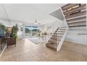 A bright and airy living room with stairs, tiled floors and access to the outdoors at 2424 W Tampa Bay Blvd # G204, Tampa, FL 33607