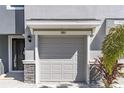 Close up of the one car garage door and front door with decorative stone accents at 2801 Midnight Pearl Dr, Sarasota, FL 34240