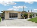 Single-story home featuring a driveway and screened-in garage in a well-maintained neighborhood with mature landscaping at 3401 Pinon Dr, Holiday, FL 34691
