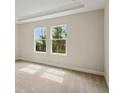 Bright bedroom featuring plush carpet and two windows at 3448 Yellow Leaf Cir, Spring Hill, FL 34609