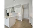 Bright kitchen with quartz counters, subway tile backsplash, stainless appliances, and tile floor at 3458 Yellow Leaf Cir, Spring Hill, FL 34609