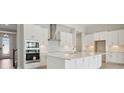 Bright kitchen featuring all-white cabinets, stainless steel appliances, and backsplash at 3458 Yellow Leaf Cir, Spring Hill, FL 34609